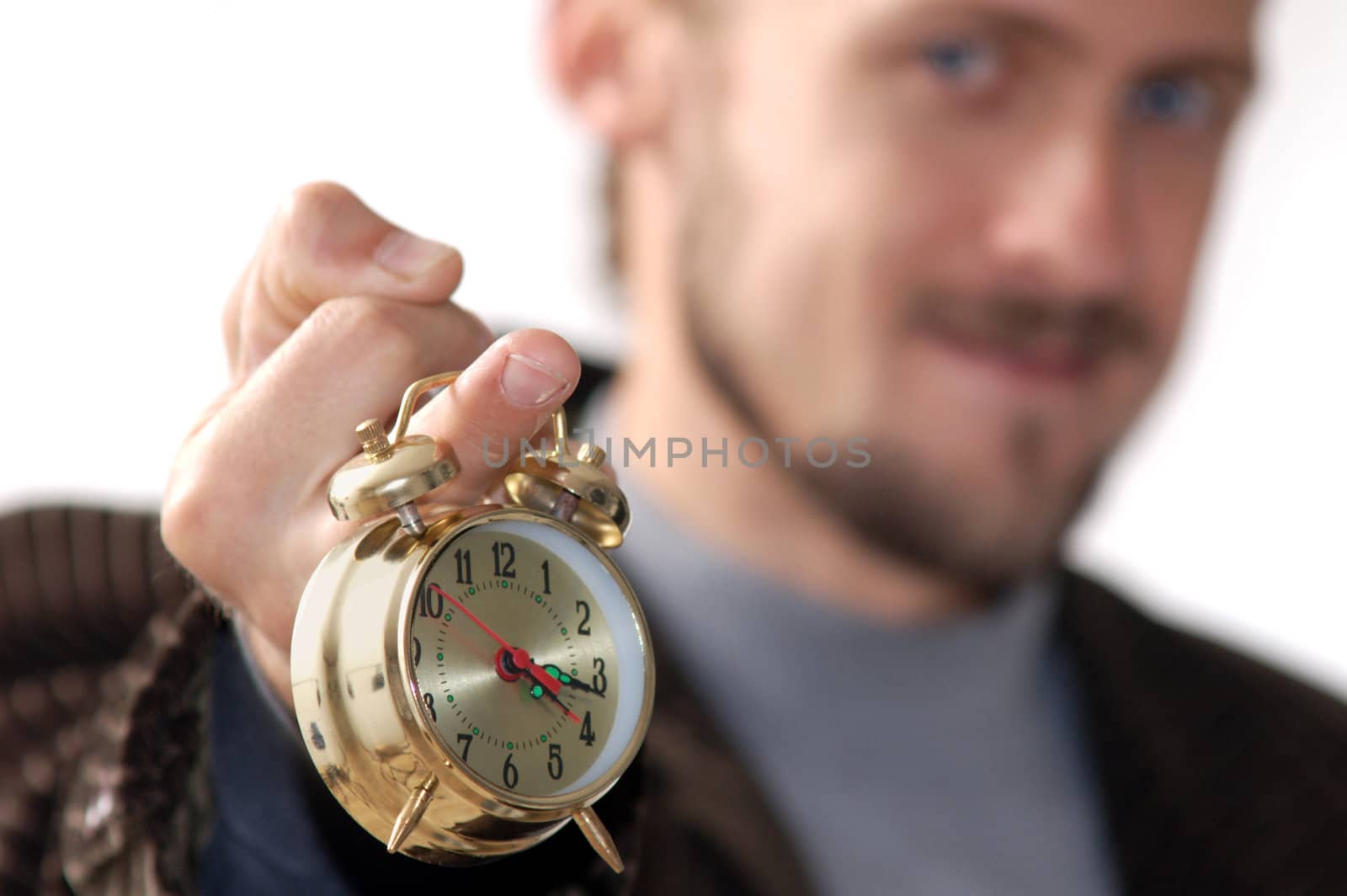 A man keeping an alarm clock in his finger