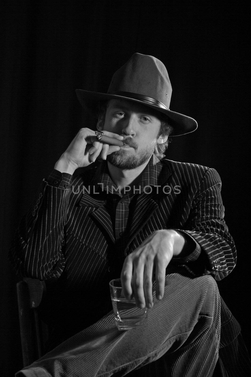 An image of a bearded man smoking cigar
