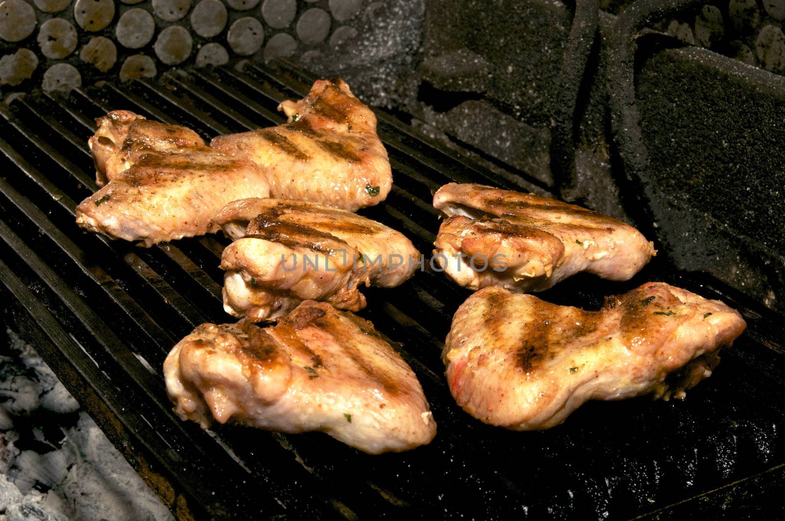 chicken wings are fried on the grill