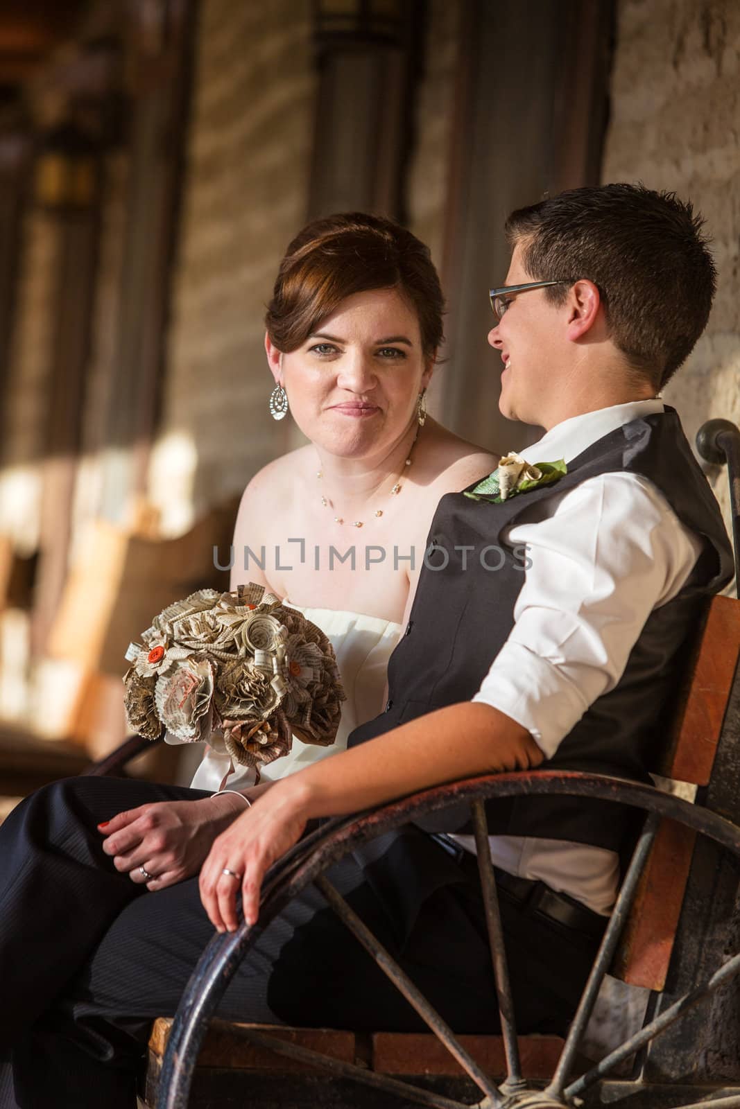 Happy bride with partner on antique bench