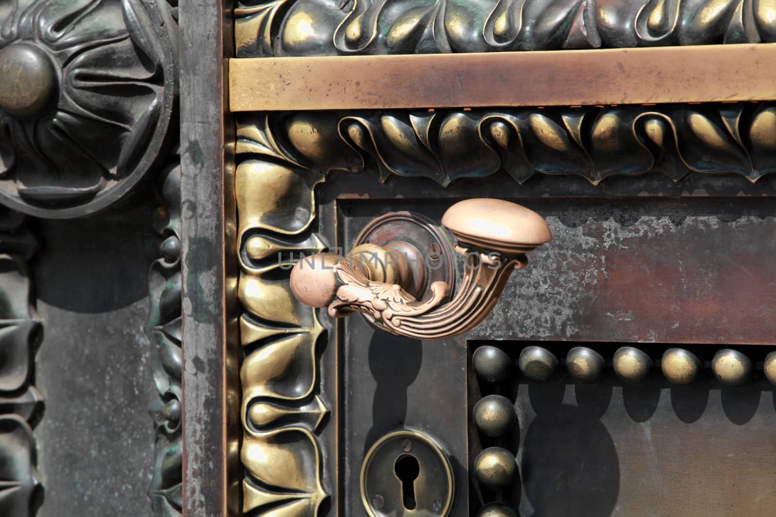 fragment of antique brass door with ornaments, close-up