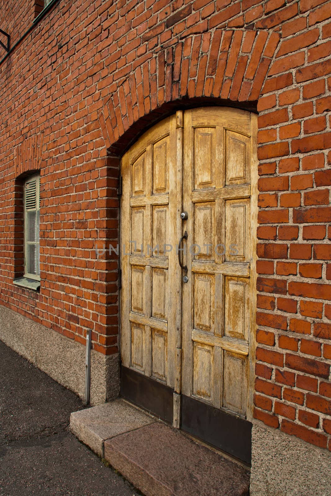 Old wooden door with tile wall