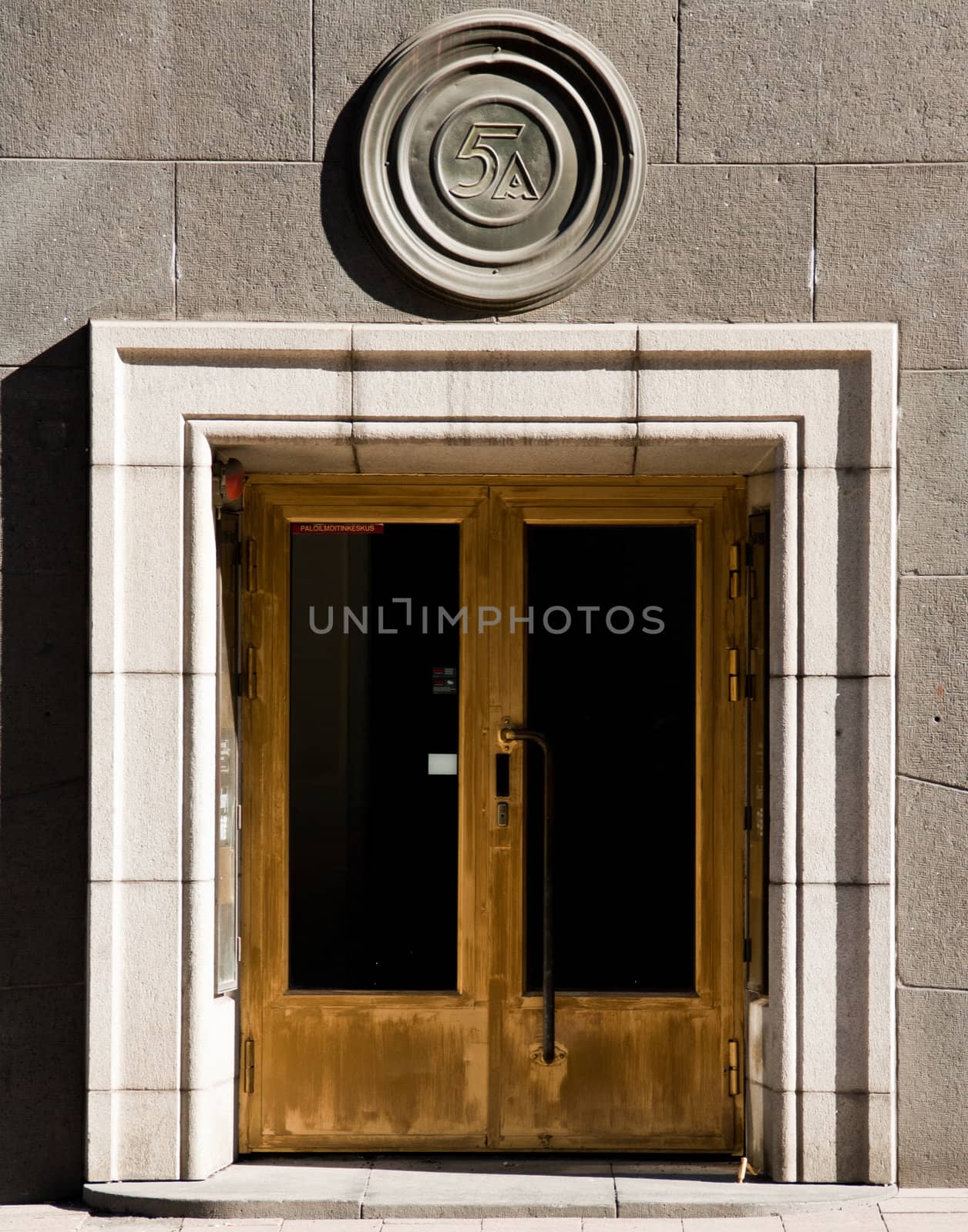 Old door in front of concrete building
