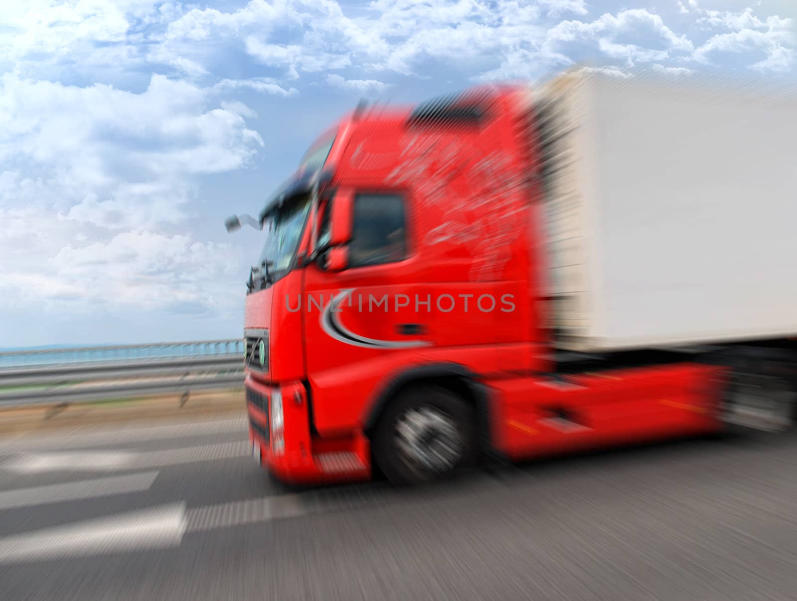 White truck on highway, sky with clouds