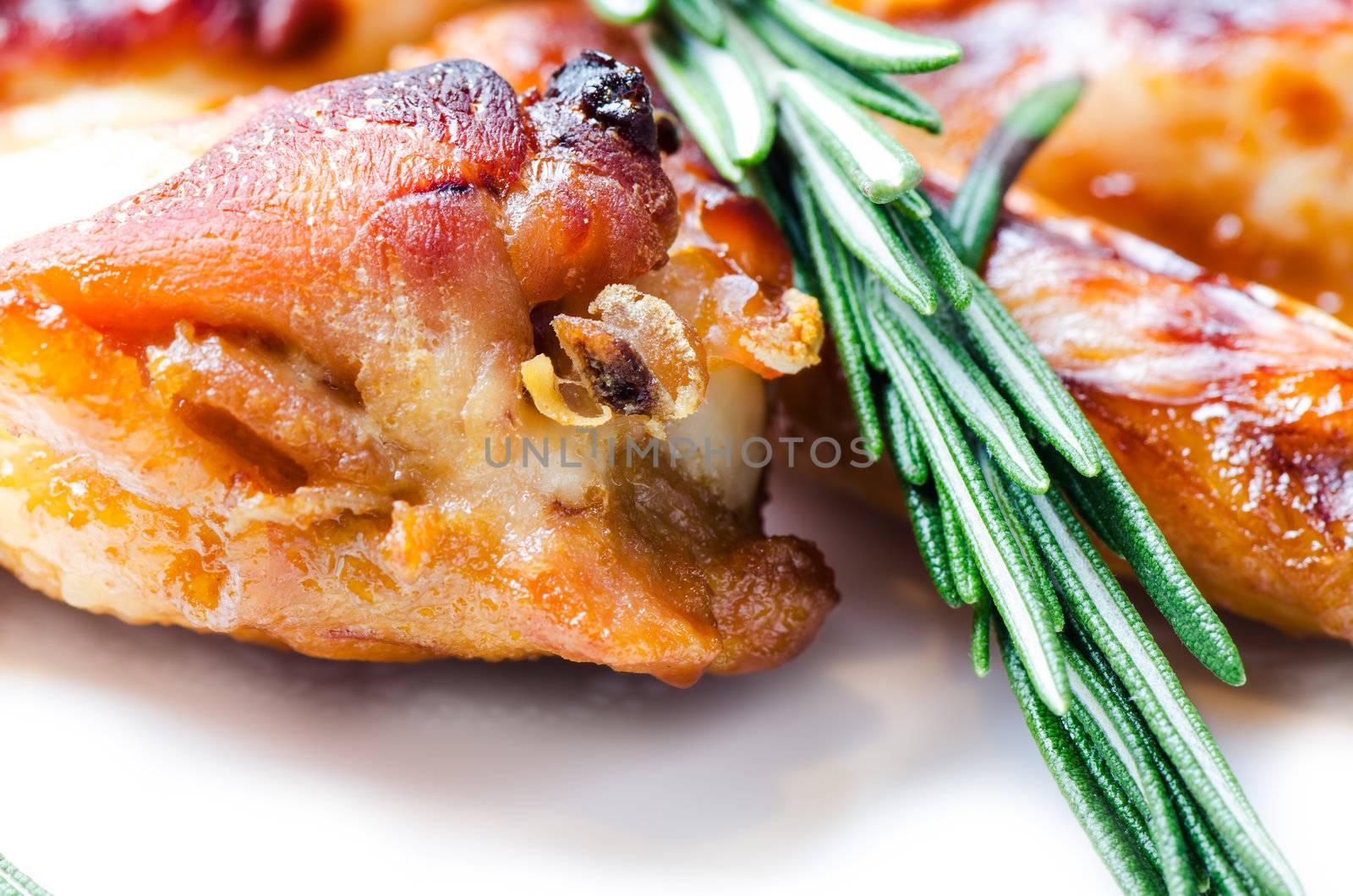 Fried chicken wings with a sprig of rosemary by Nanisimova