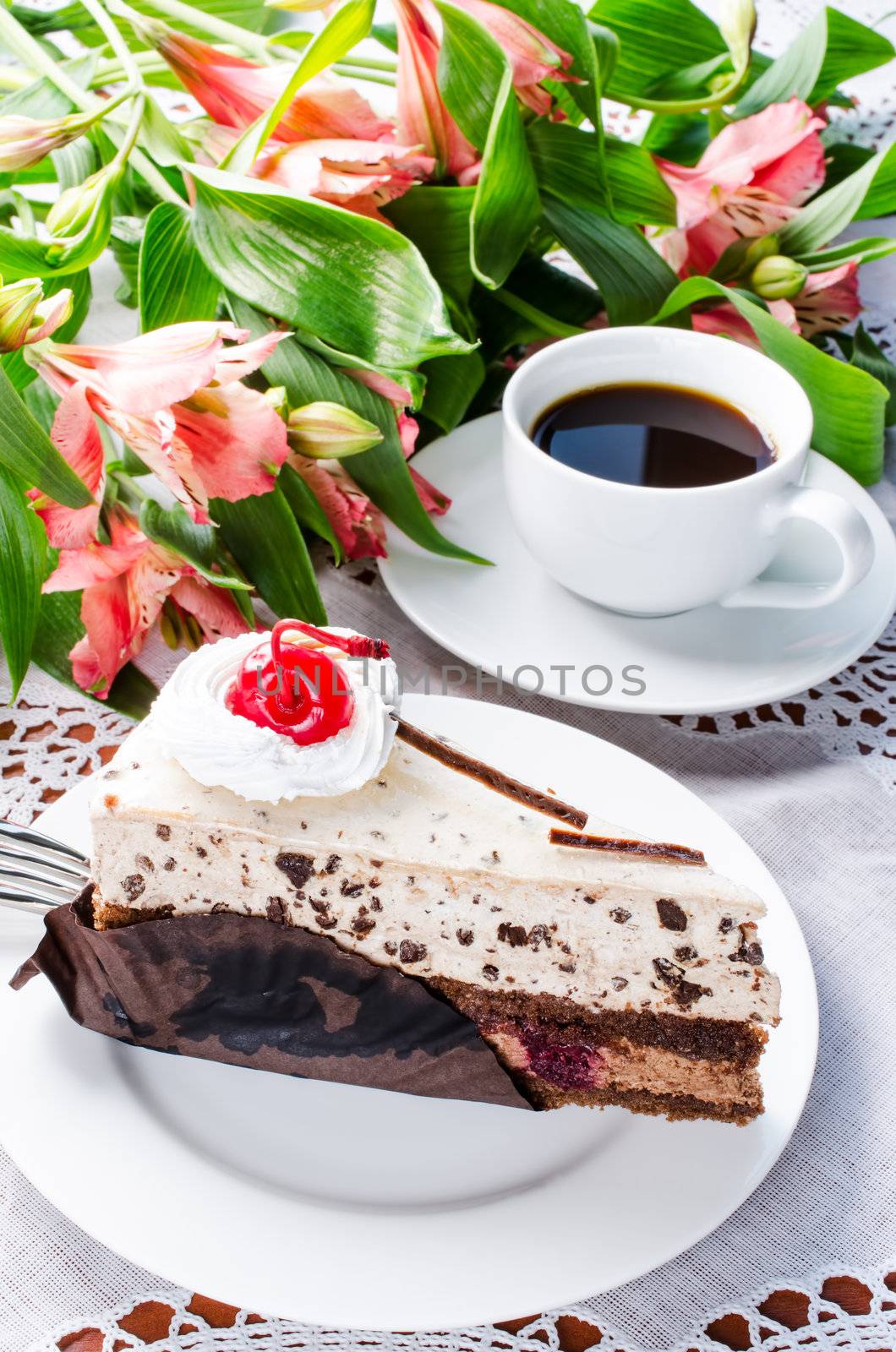 Cake coffe and flowers on table cloth
