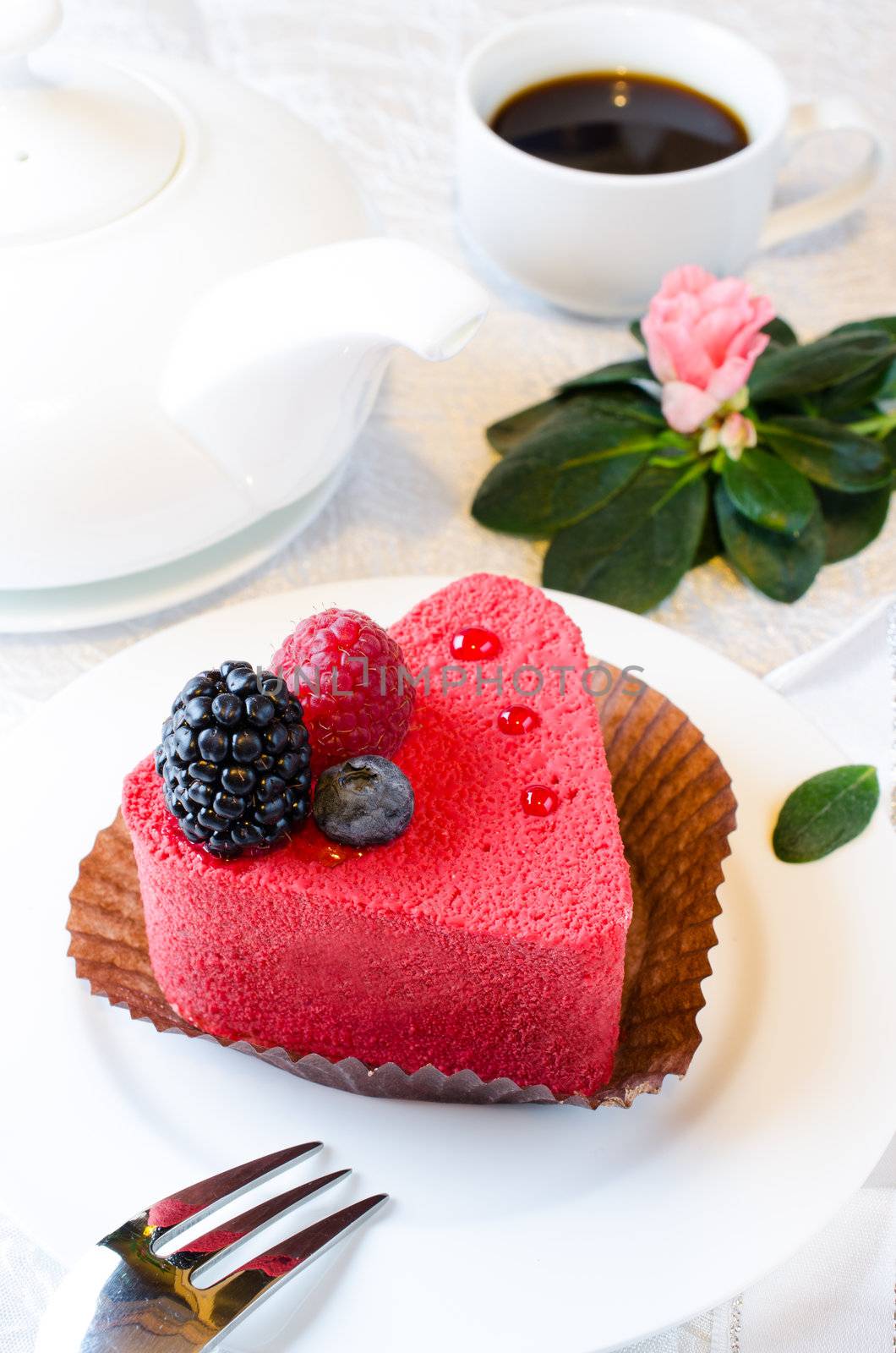 Red heart shaped cake with cofee and pink azalia flower