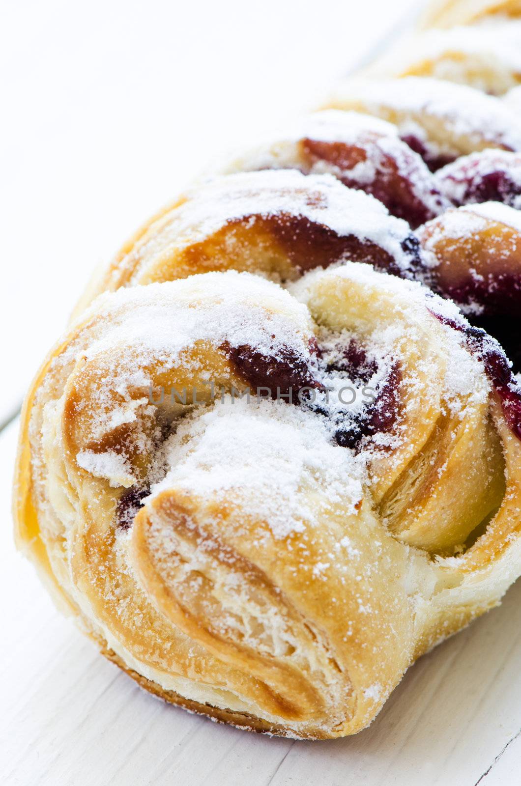 Close up detail of pastry with jam and sugar powder