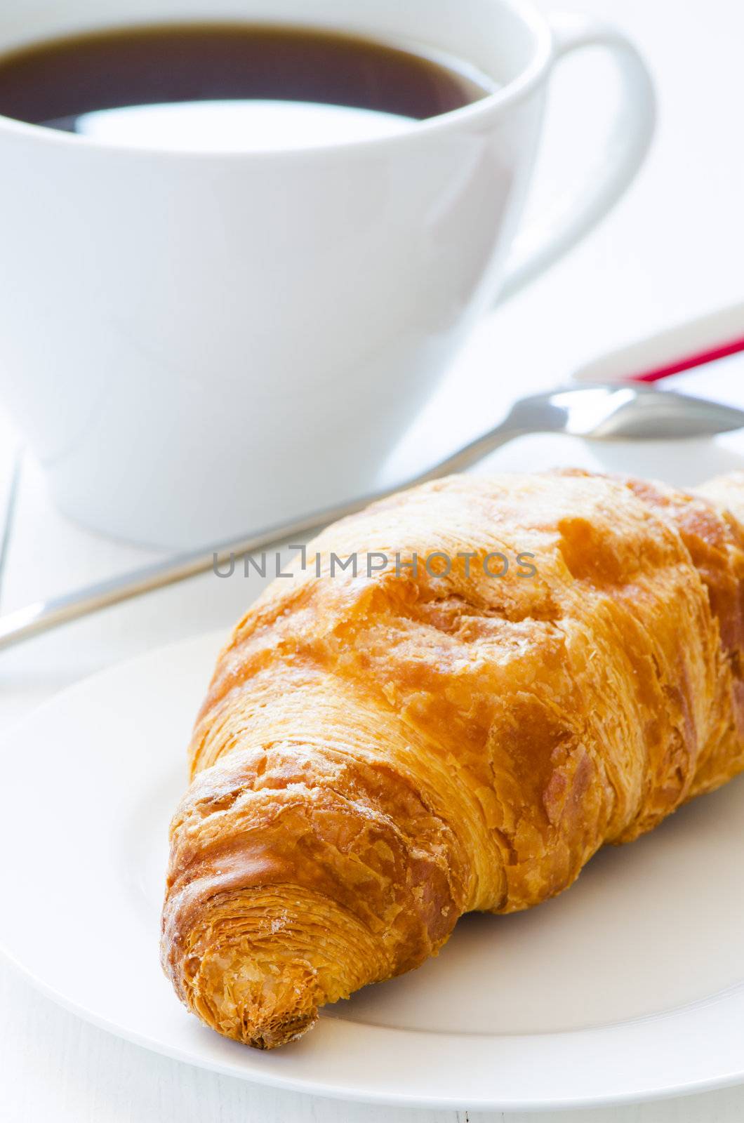 Croissant with coffeee on a background