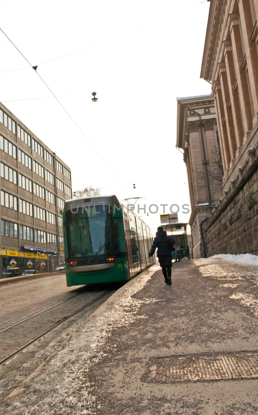 Stopping tram and a passenger in a hurry