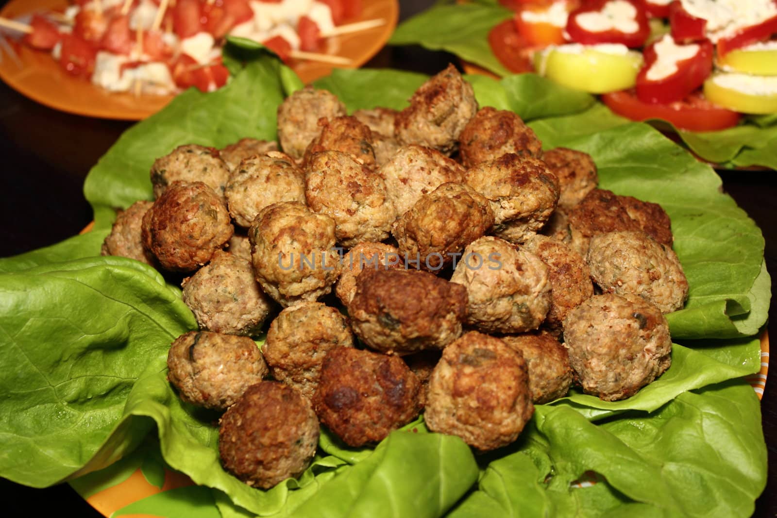 meatballs and green salad set on a plate