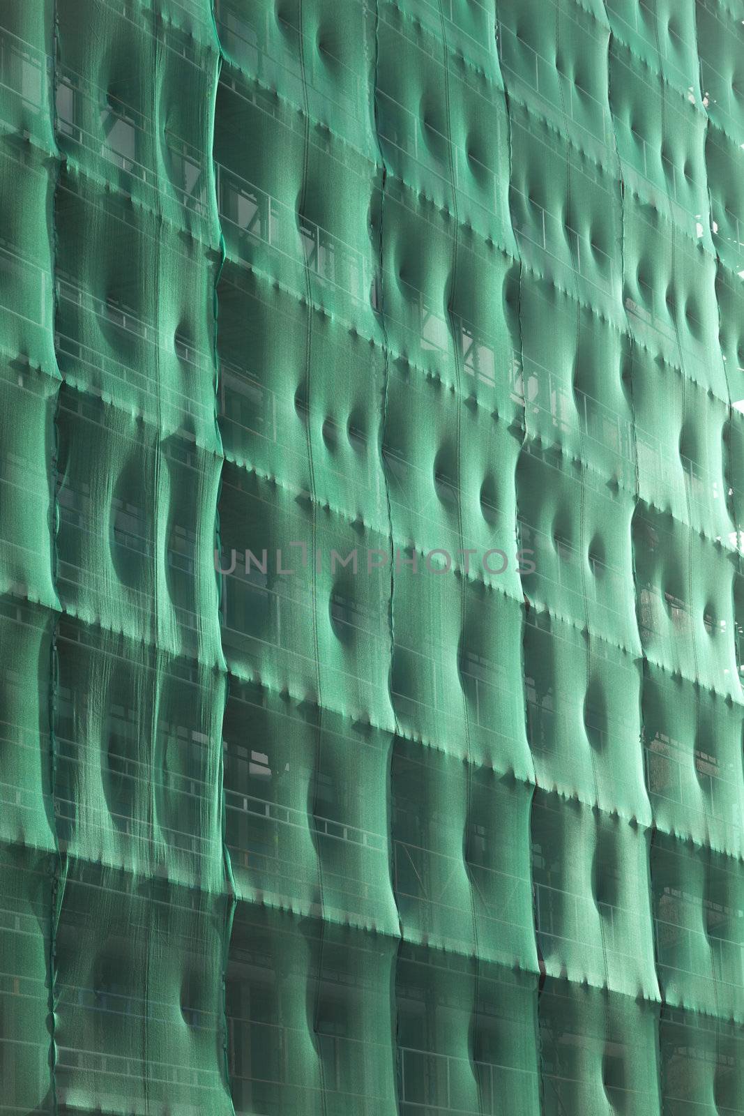 Front of Building, covered with green net ready for renovation.