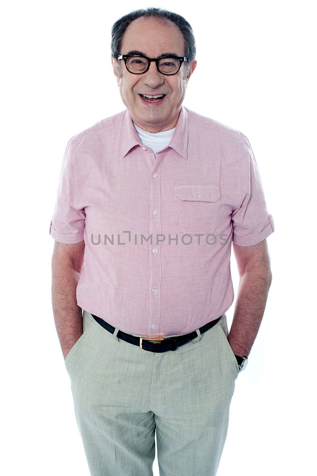 Smiling casual senior man with hands in pocket isolated on white