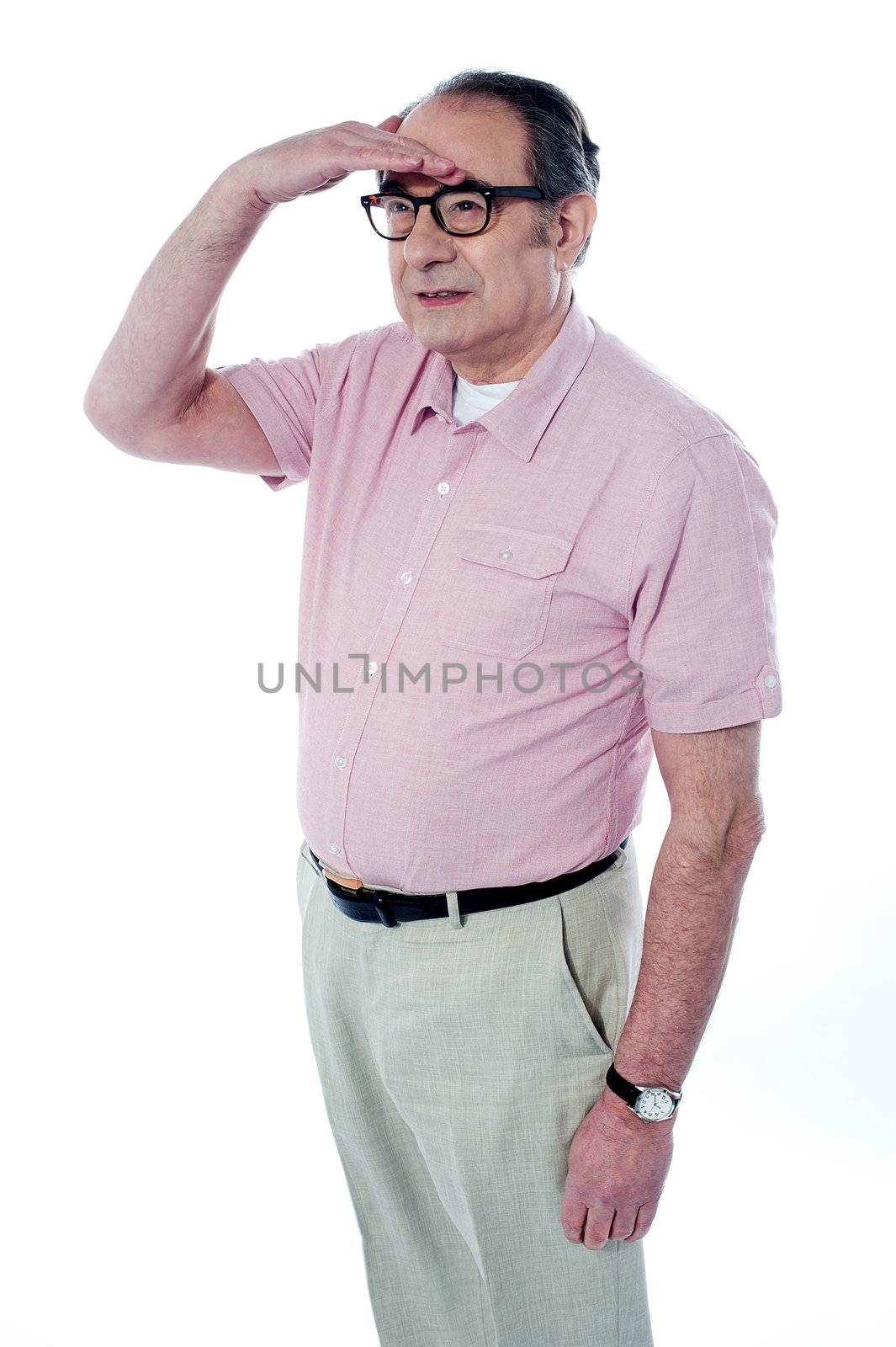 Old man looking far away by, studio shot