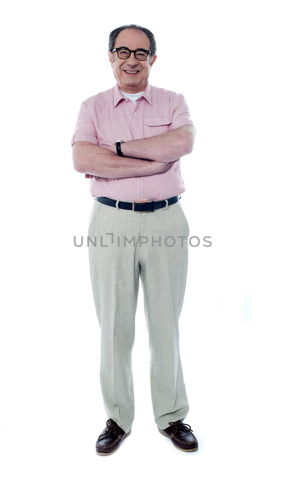 Matured person posing with folded hands, smiling at camera