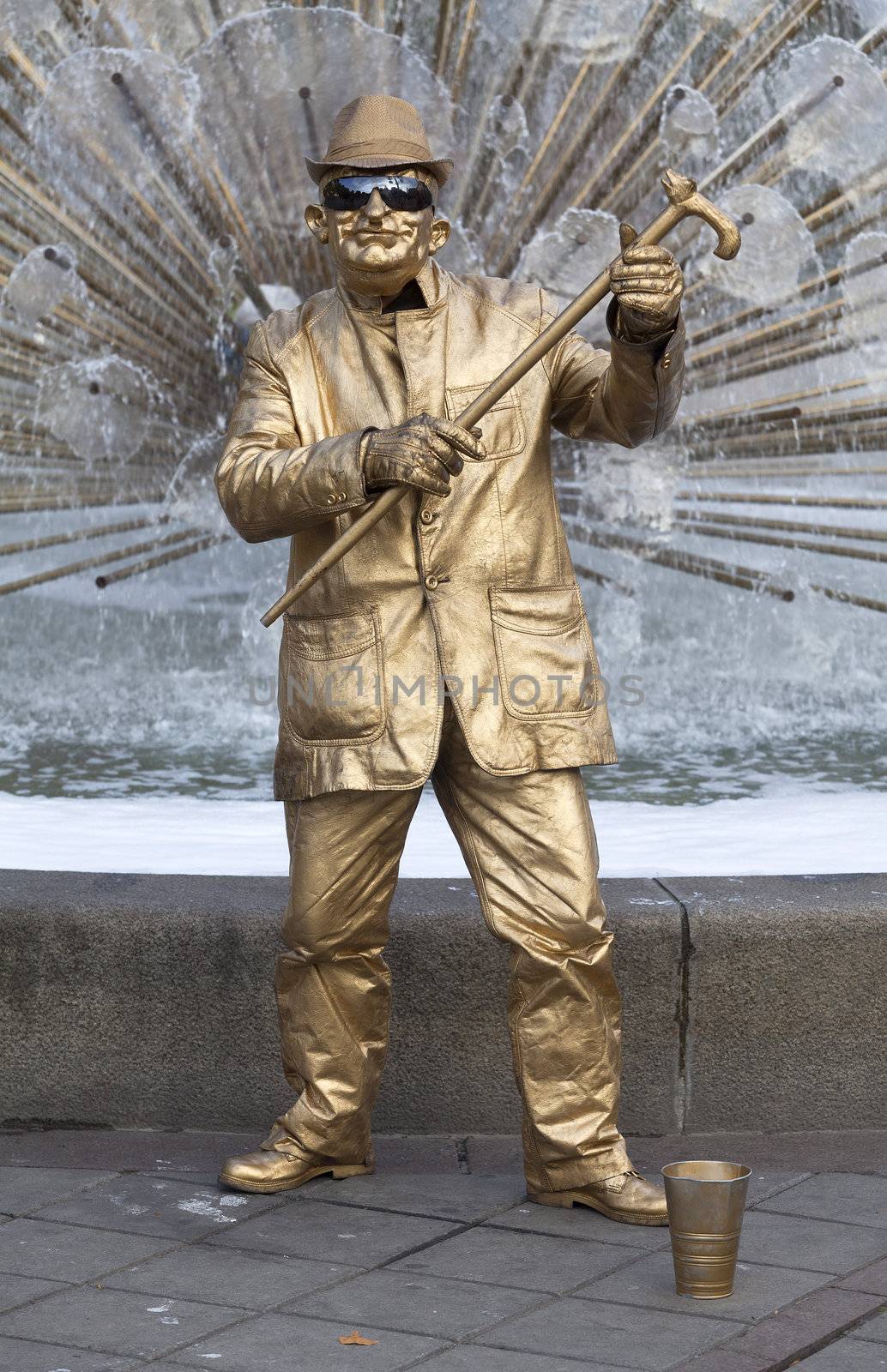 Men dressed in gold gives the appearance in a central square in the city of Oslo, Norway