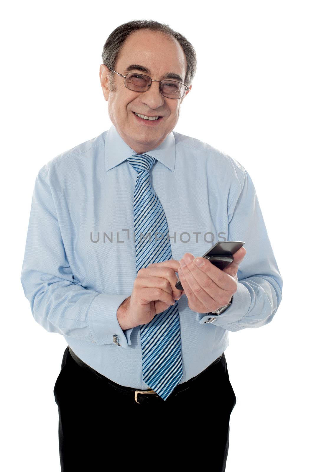 Elder business executive texting on phone in front of camera