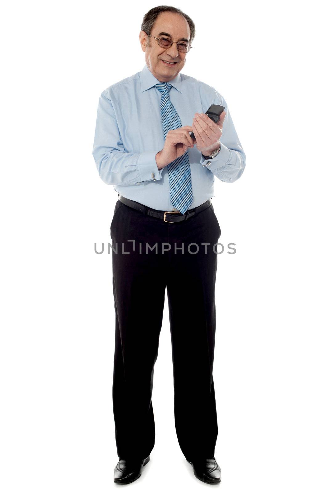 Handsome old corporate man using cellphone by stockyimages