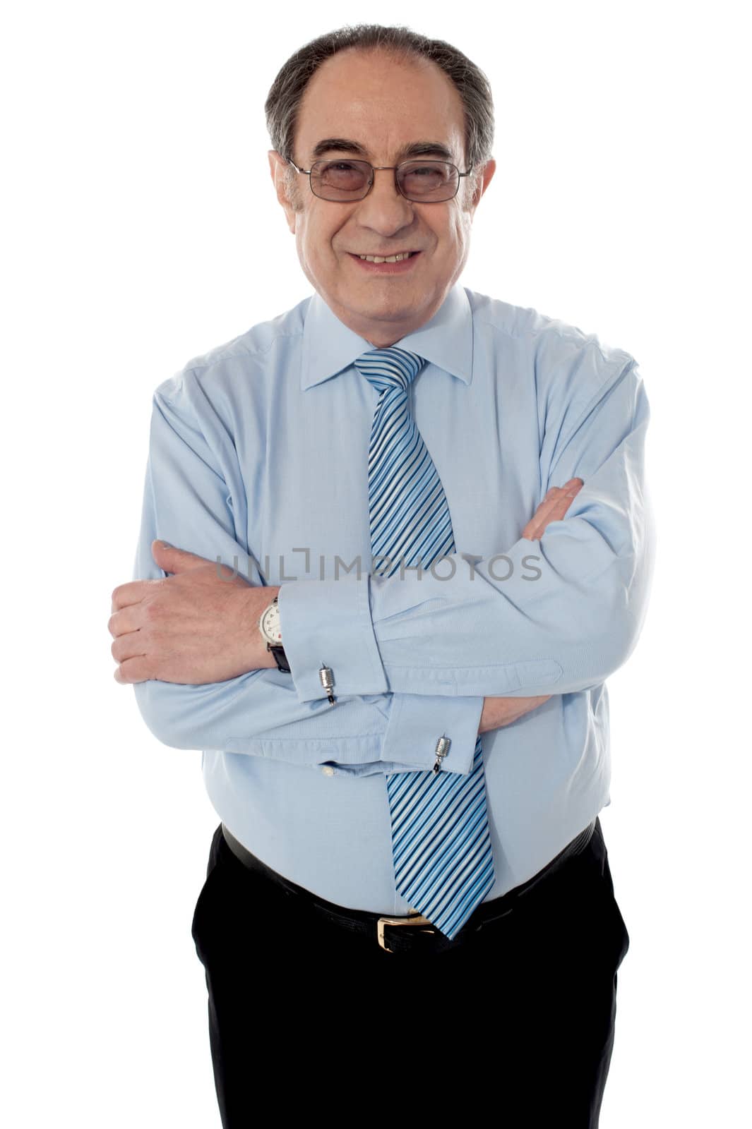 Closeup shot of smiling matured businessman posing with folded arms, looking at camera