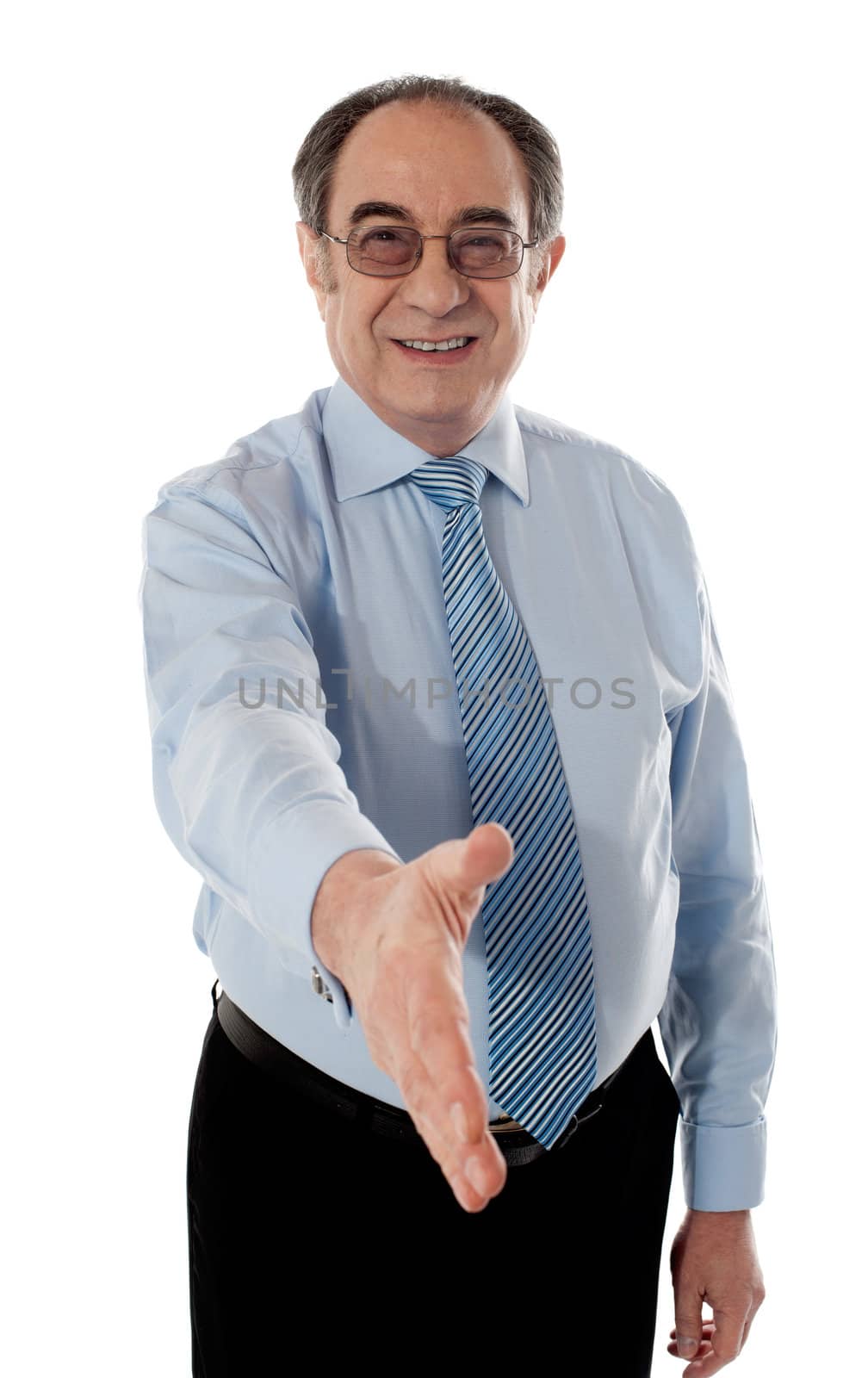 Confident modern businessman offering handshake by stockyimages