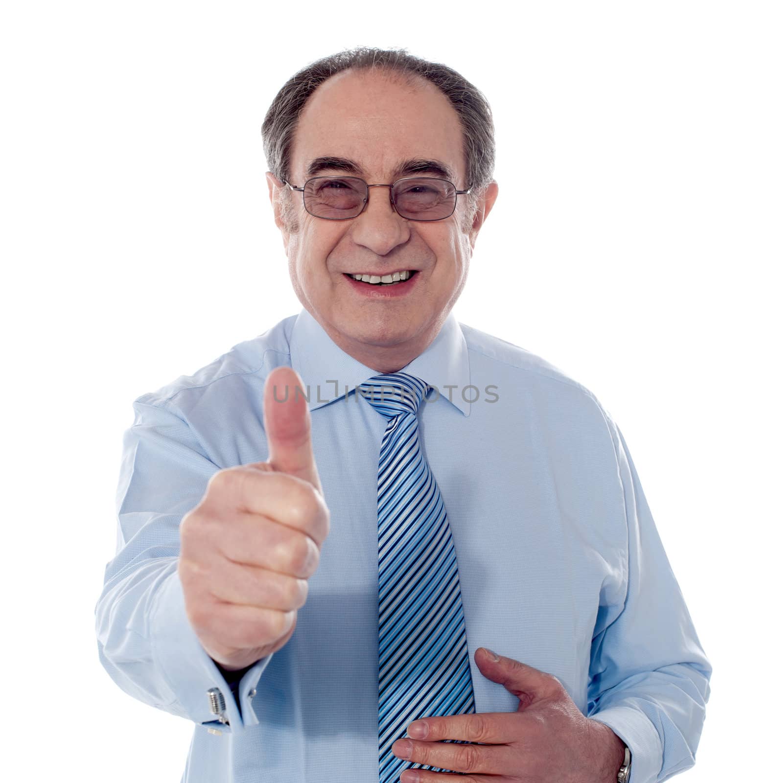 Smiling mature businessman showing thumbs-up by stockyimages