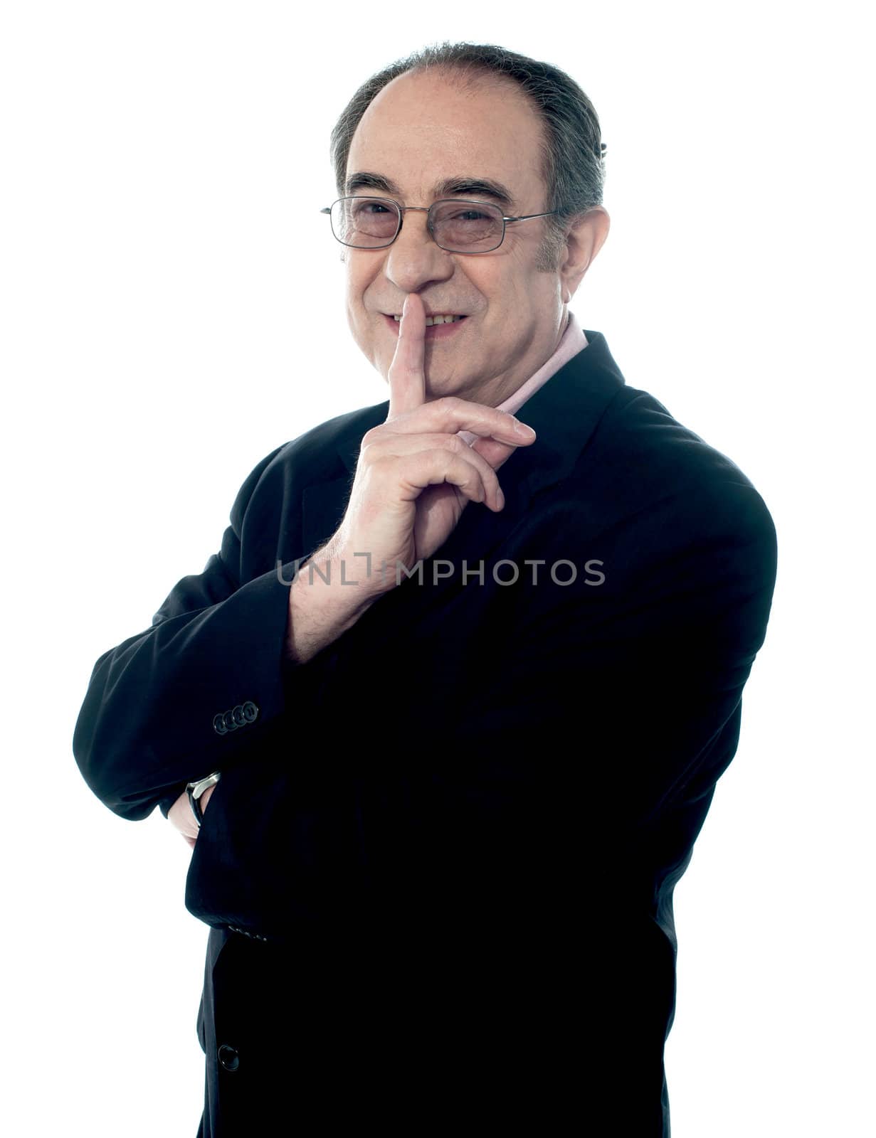 Corporate male gesturing silence, closeup shot by stockyimages