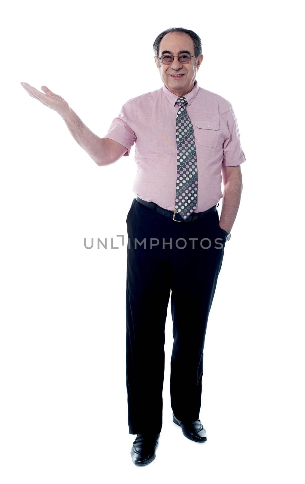 Senior boss posing with an open palm awith the other hand in pocket, stylish