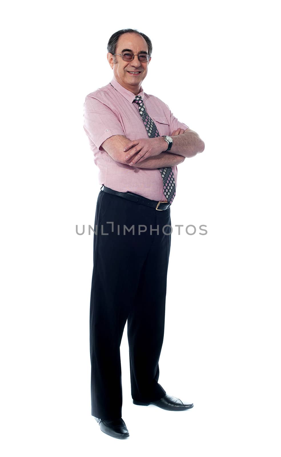 Senior business associate smiling as he poses with folded arms against white background