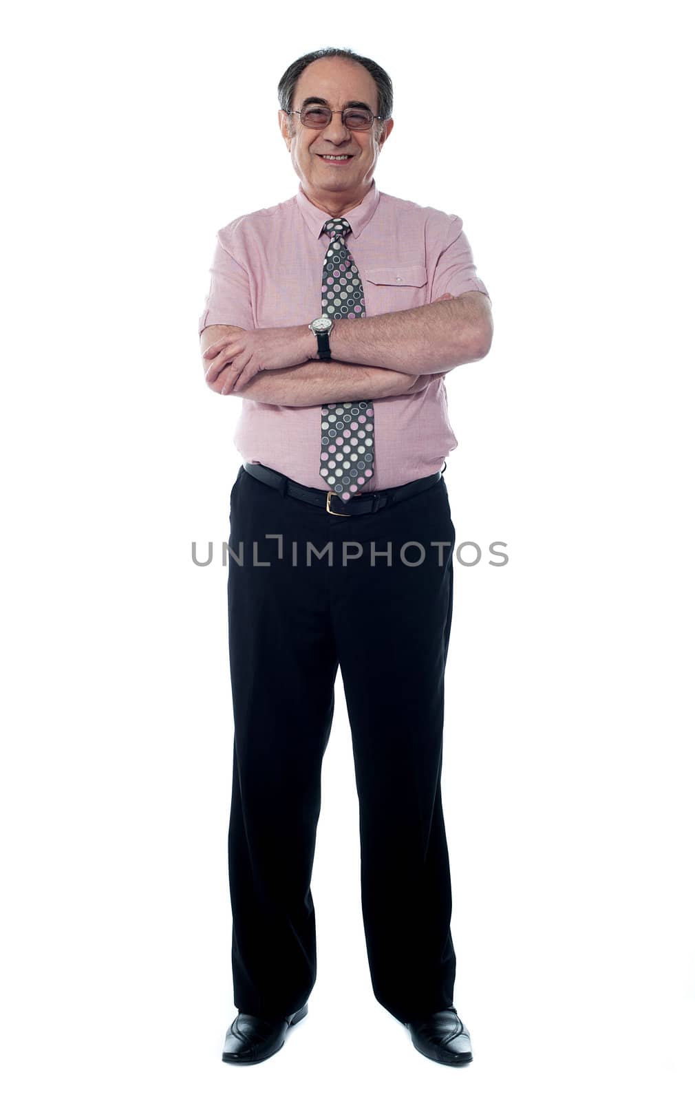 Senior business executive in pink shirt and tie posing with crossed arms isolated on white