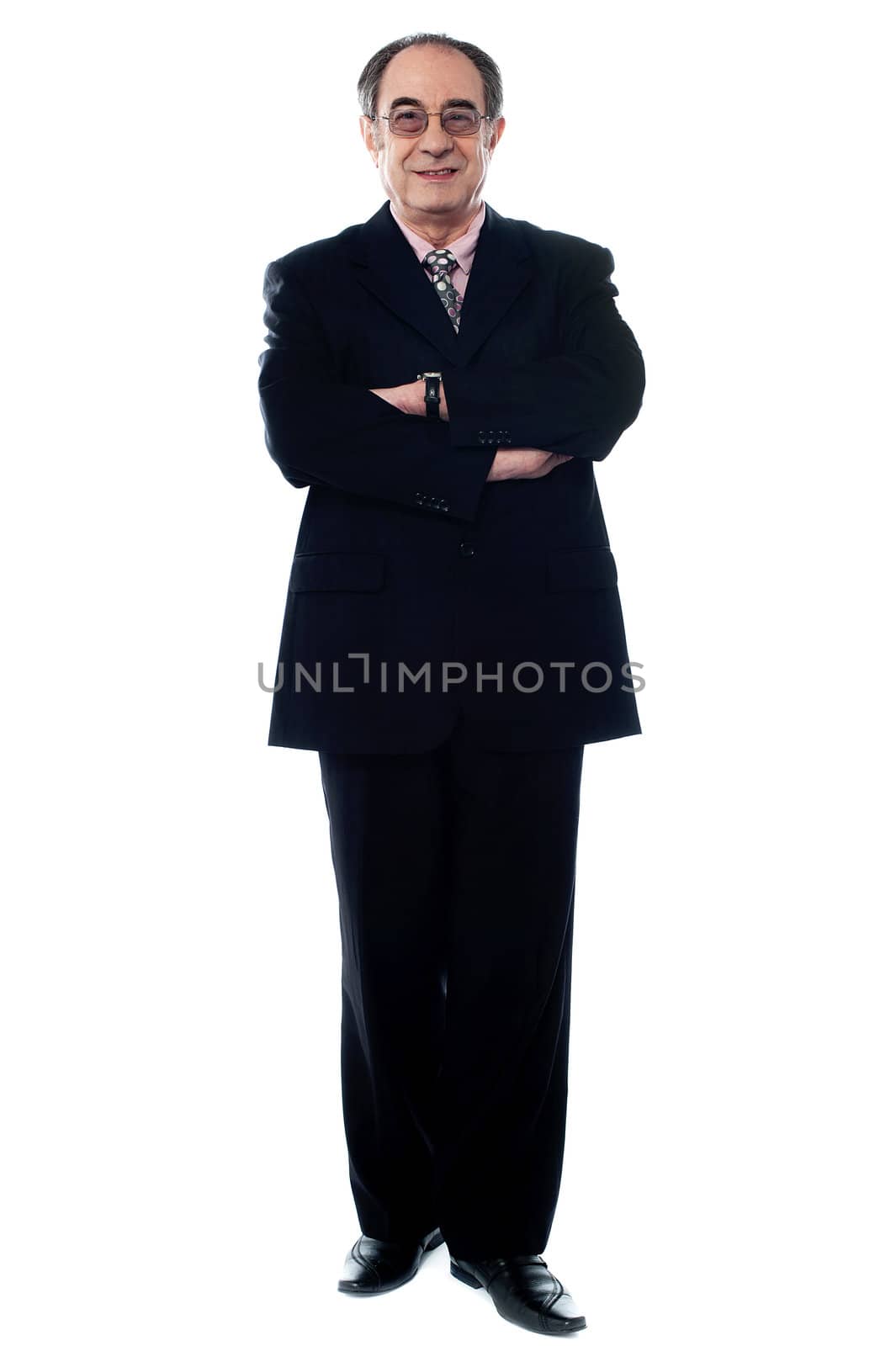 Successful businessman in black suit by stockyimages