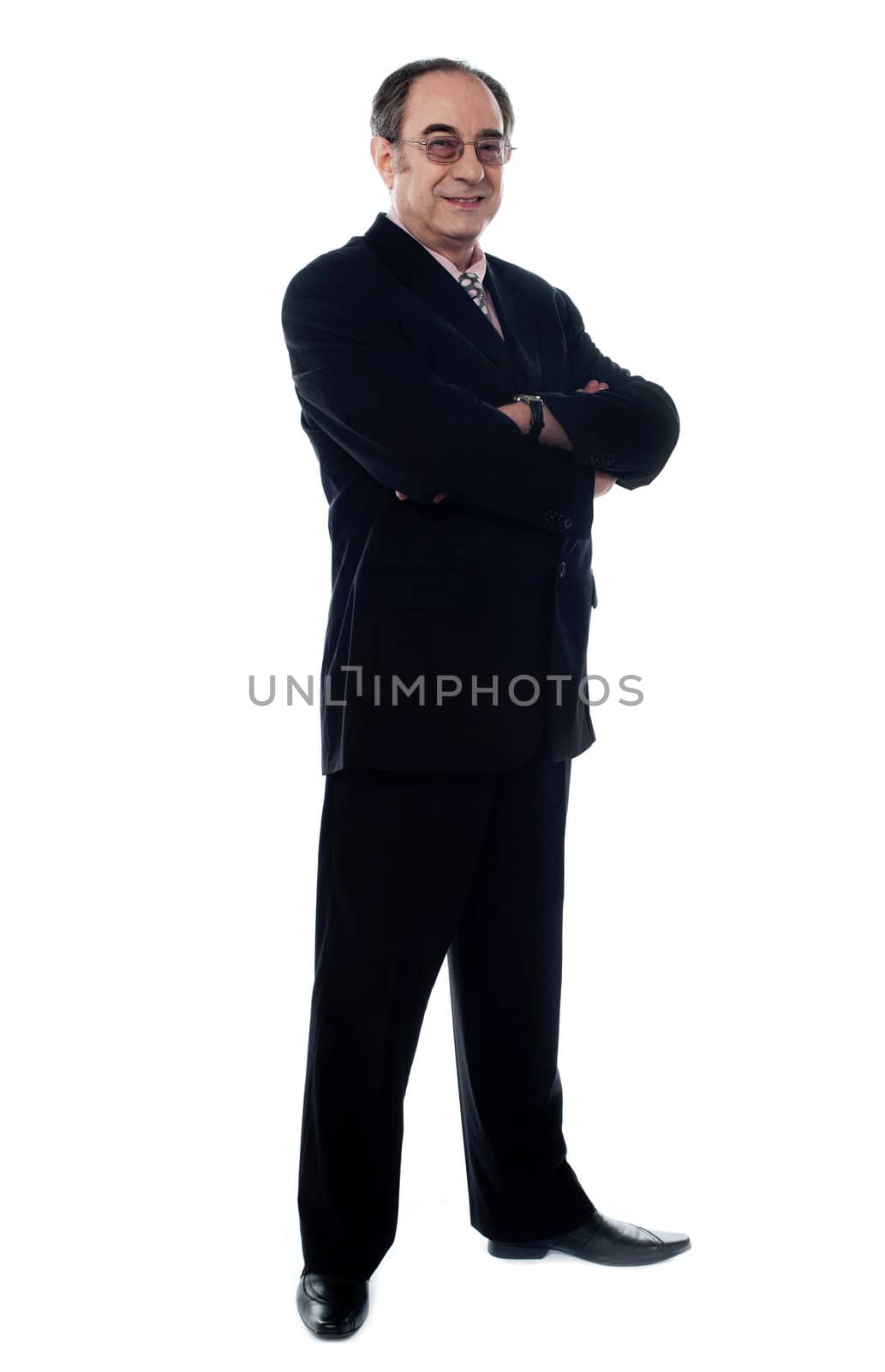 Handsome old manager standing with arms crossed by stockyimages