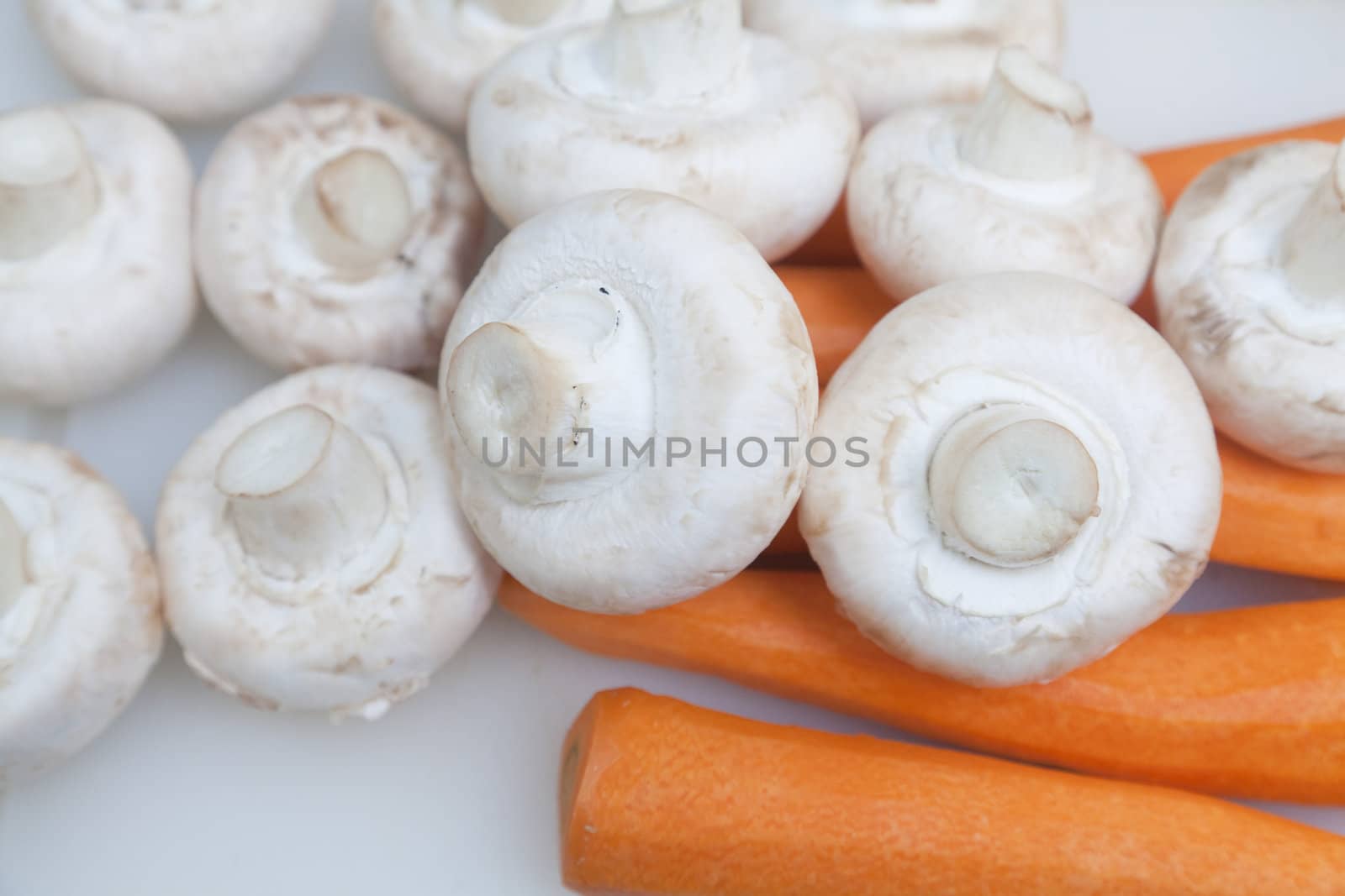 Carrots and mushrooms on the counter ready for cutting