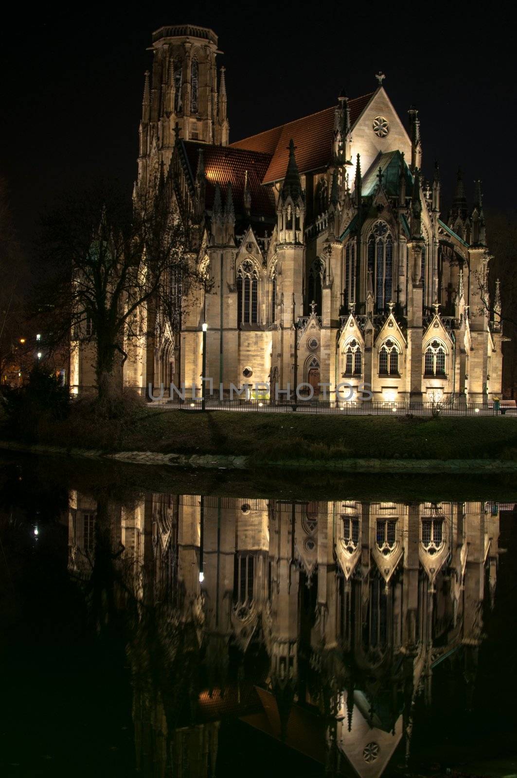 Johannes church in the middle of Feuersee in Stuttgart, Germany at night with great reflection - the church tower was destroyed during world war two. The lake was serving as water resort for the fire brigades many years ago...