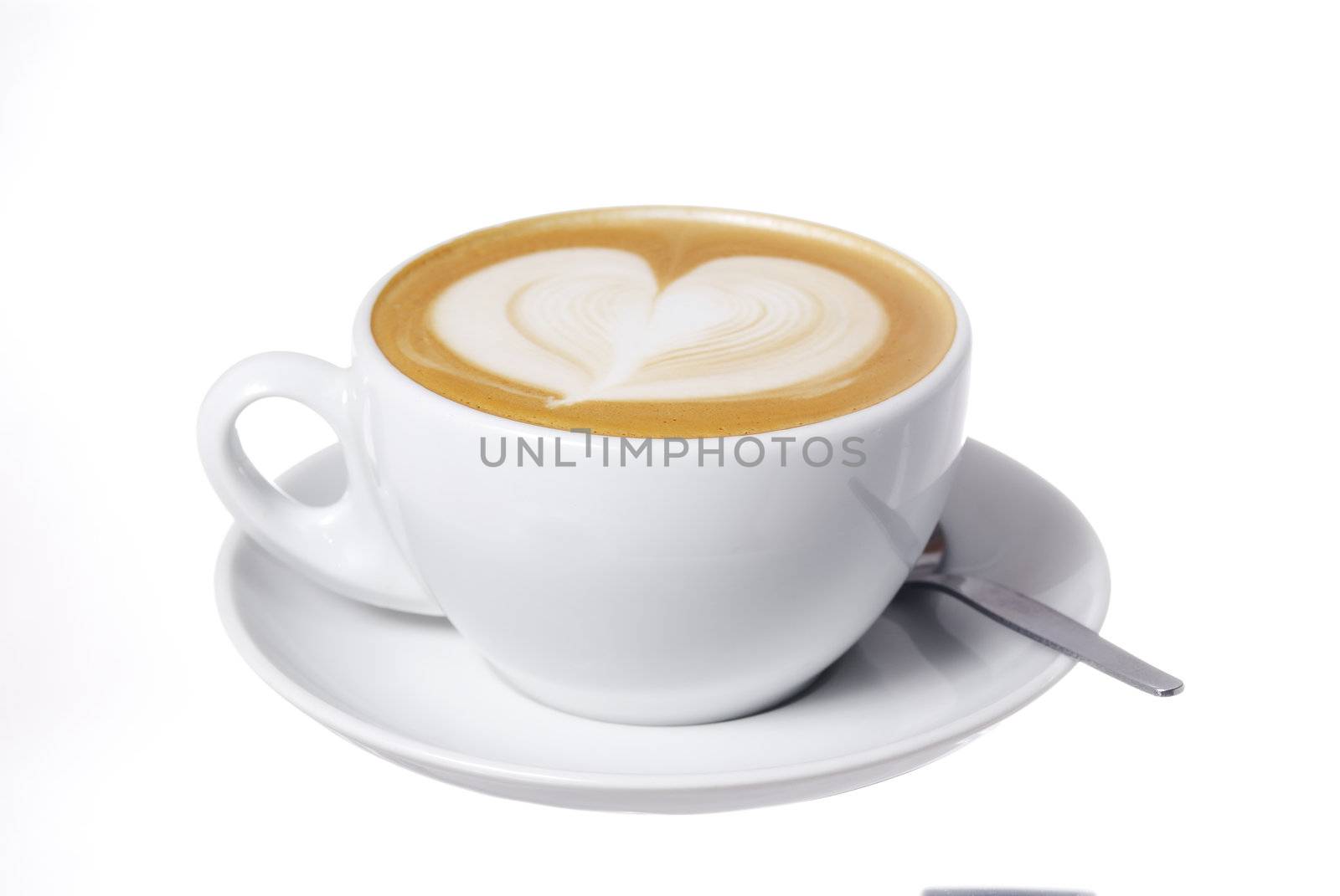 Studio shot latte cup with hear design.