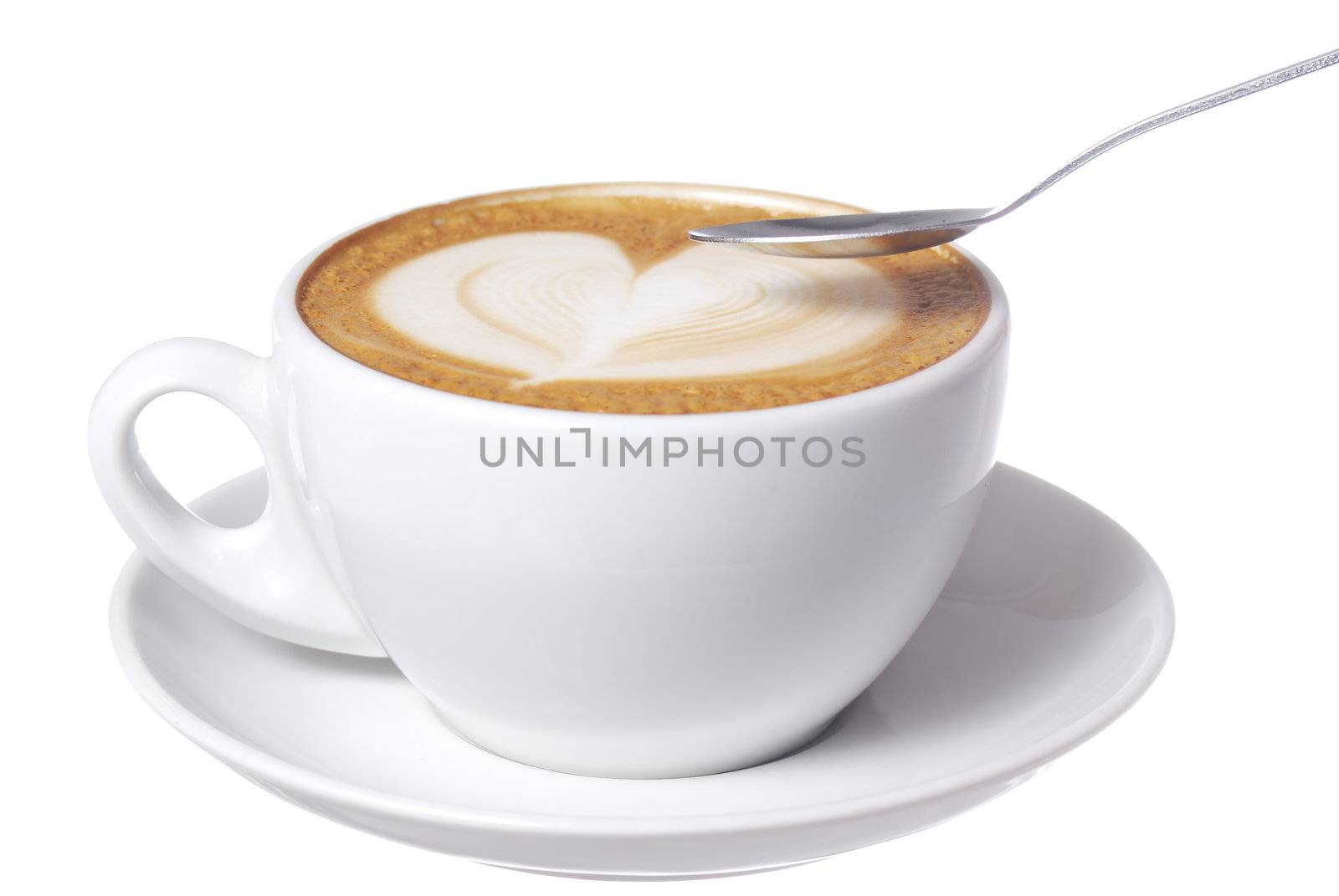 Studio shot latte cup with hear design.