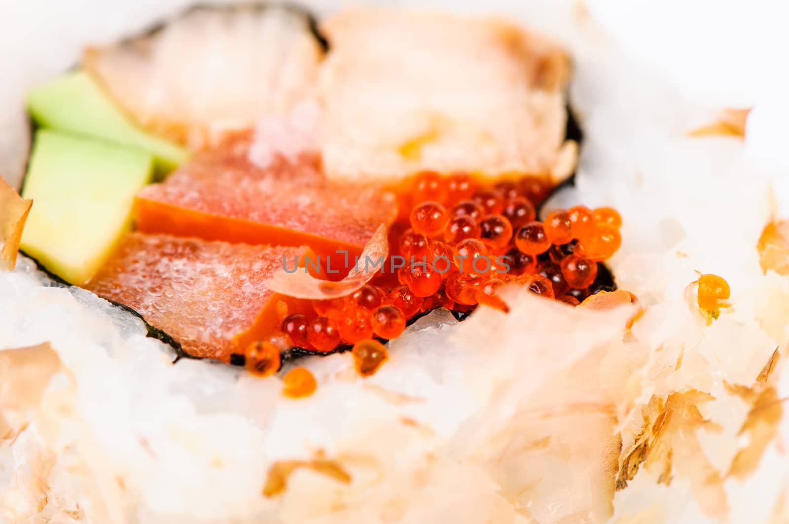 Macro sushi set with avocado, fish and red caviar on white background