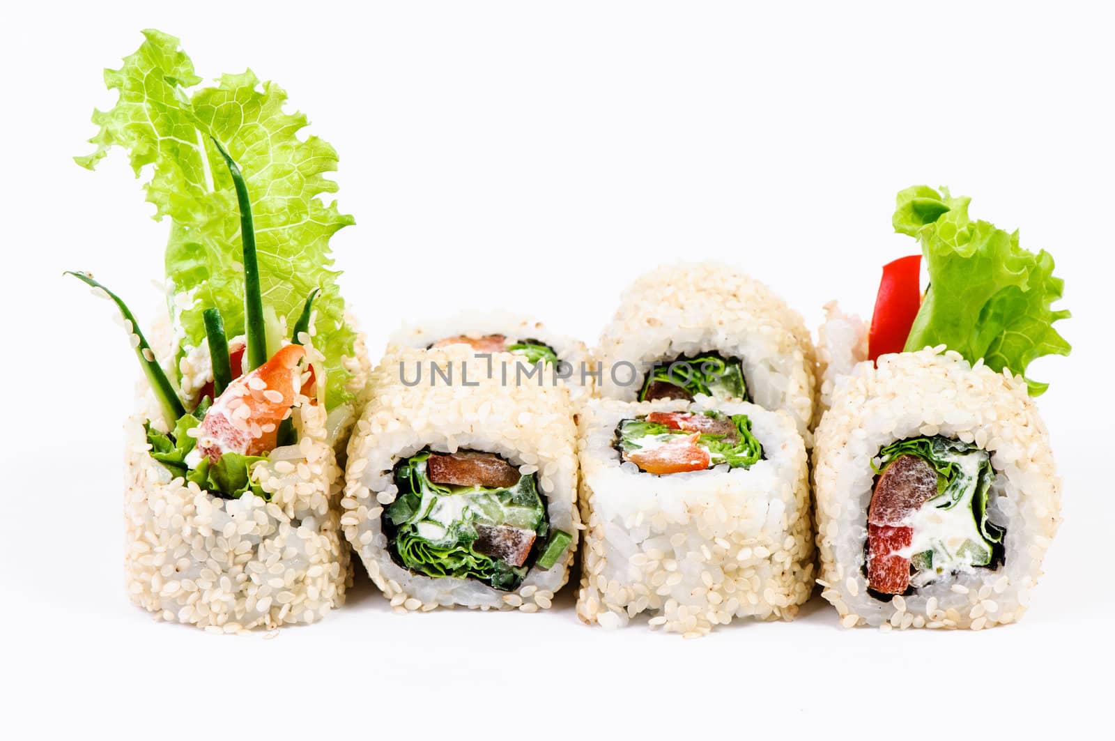 Sushi set with leawes salad and paprika on white background