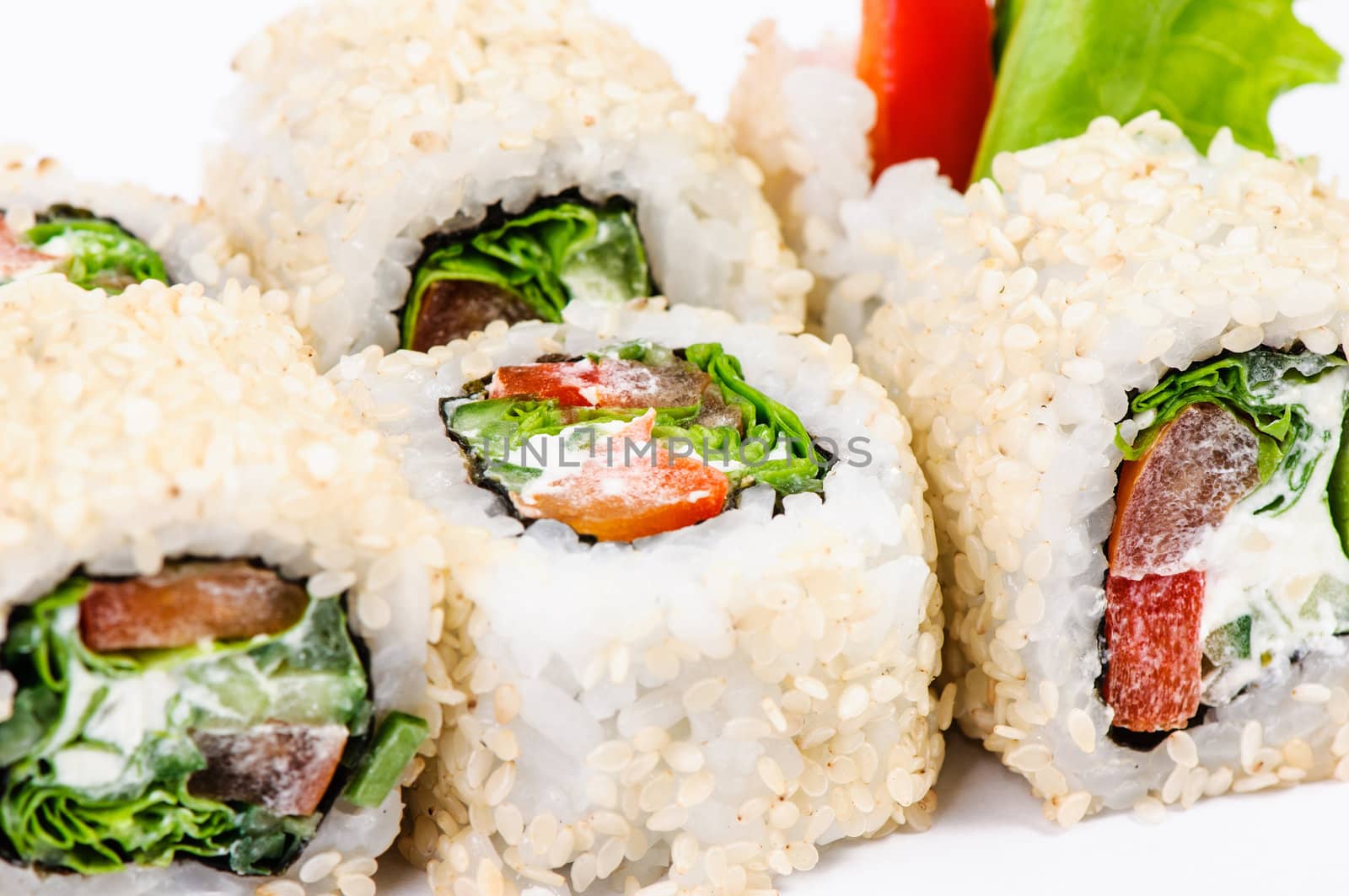 Sushi set with leawes salad and paprika on white background