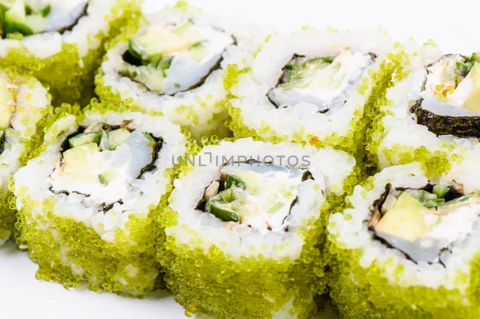 Sushi with fish and green caviar on white background