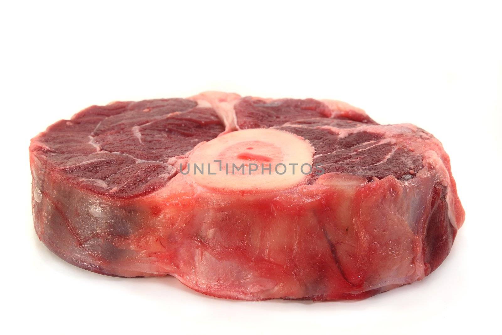 a raw leg slice on a white background