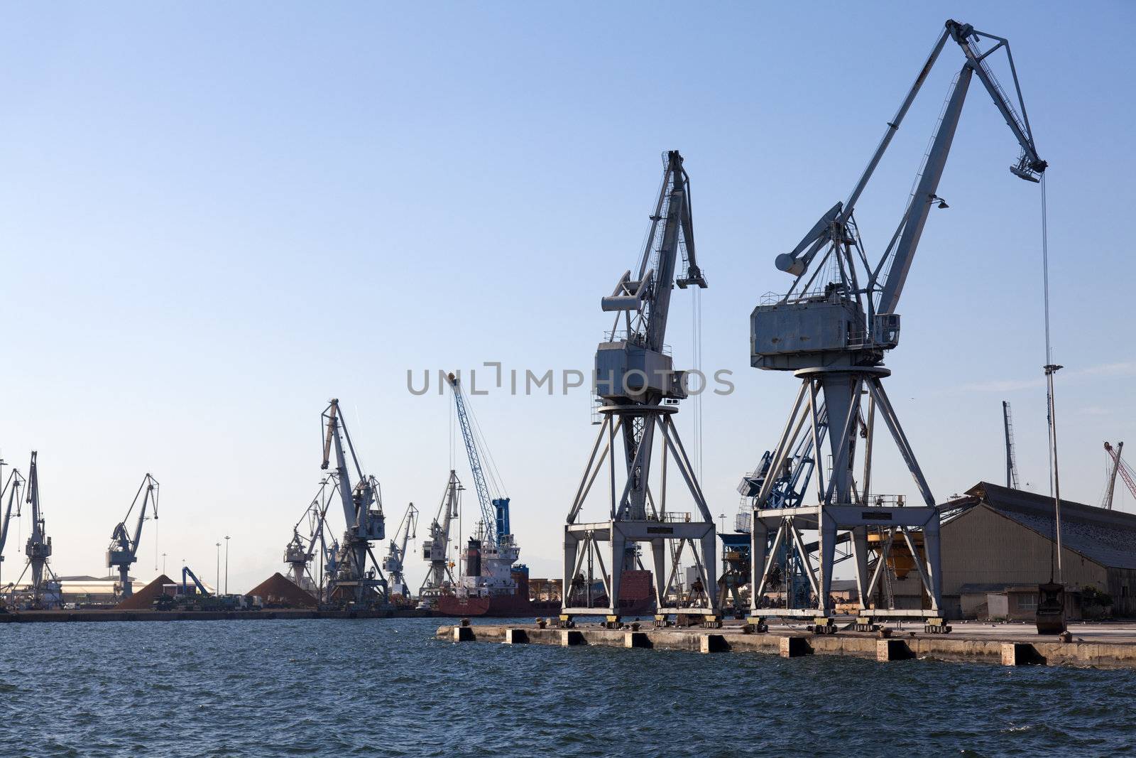 THESSALONIKI, GREECE - SEPTEMBER 29: Large cranes in the commercial section of the port of Thessaloniki working in the transport of products on September 29, 2011 in Thessaloniki, Greece