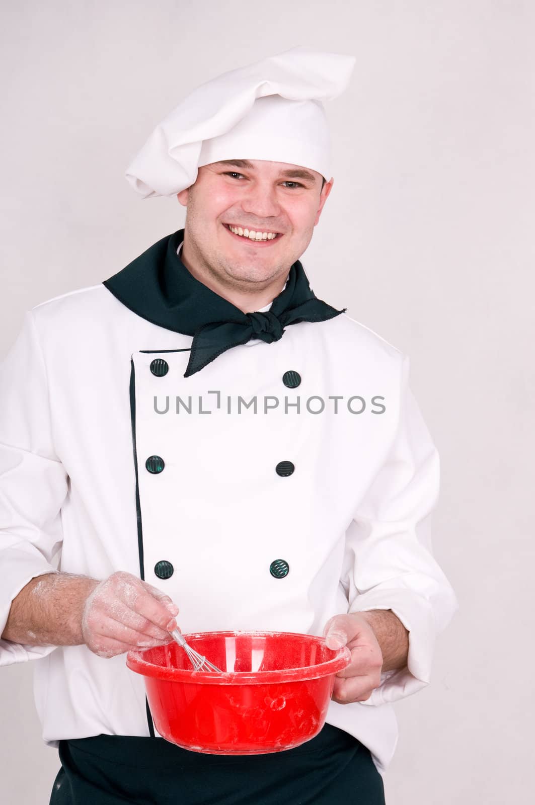 smiling chef mixes the dough in a bowl