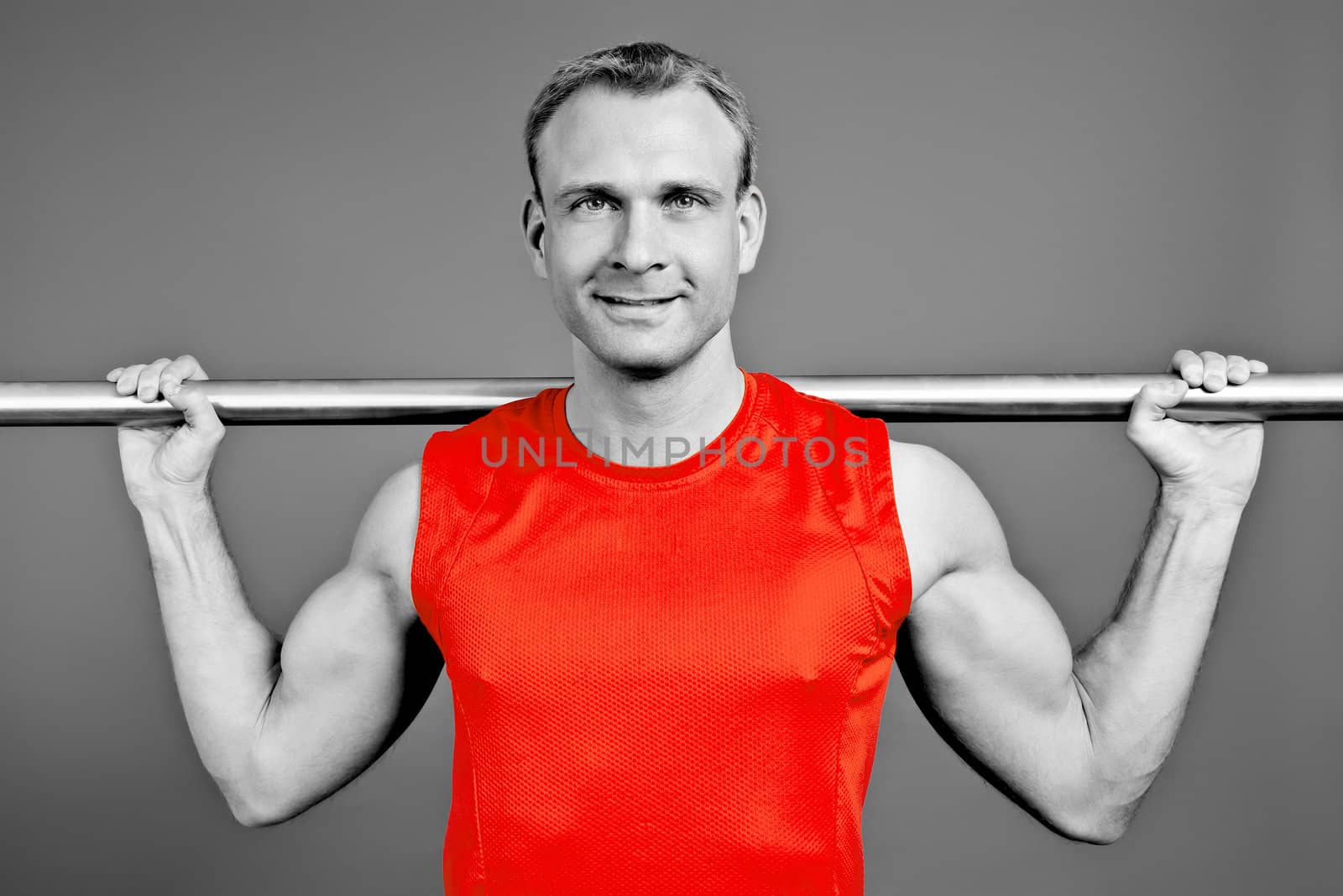 An image of a fit man in a red shirt