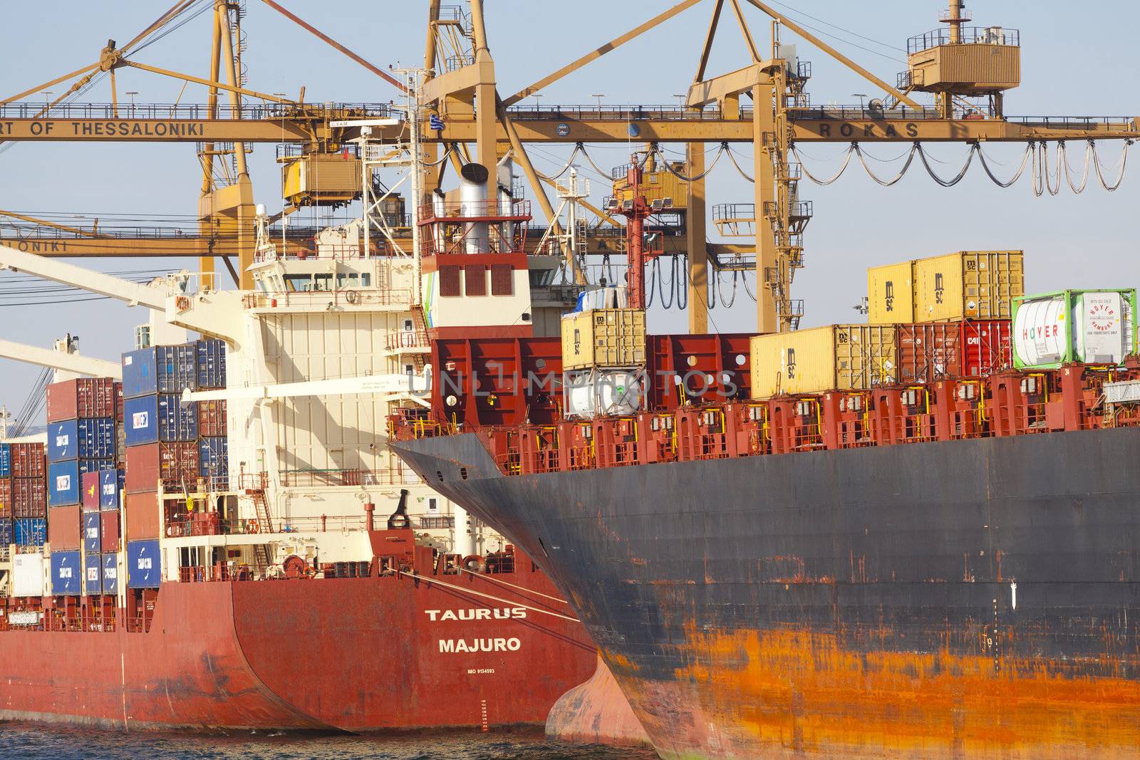 THESSALONIKI, GREECE - SEPTEMBER 29: Cranes load containers with products to ships in the port of Thessaloniki on September 29, 2011 in Thessaloniki, Greece