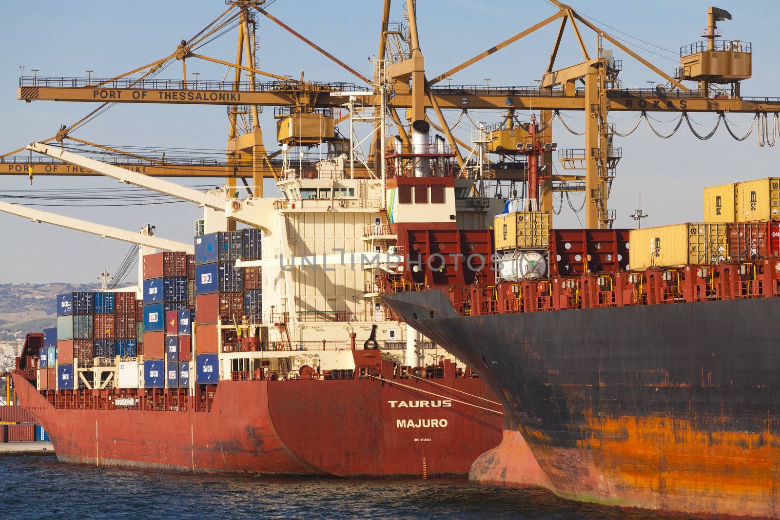 THESSALONIKI, GREECE - SEPTEMBER 29: Cranes load containers with products to ships in the port of Thessaloniki on September 29, 2011 in Thessaloniki, Greece