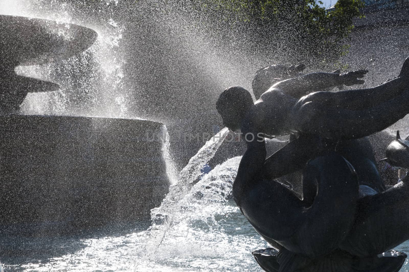 Detail of statue by water fountain in Trafalgar Square, central London, UK