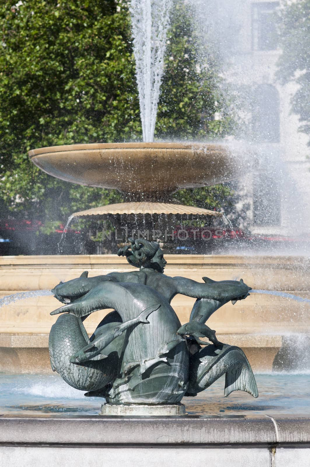 Detail of statue by water fountain in Trafalgar Square, central London, UK