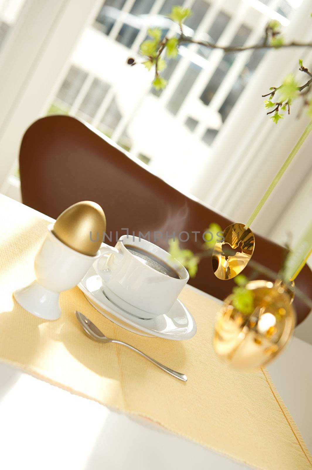 Easter morning coffee and gold decorated egg