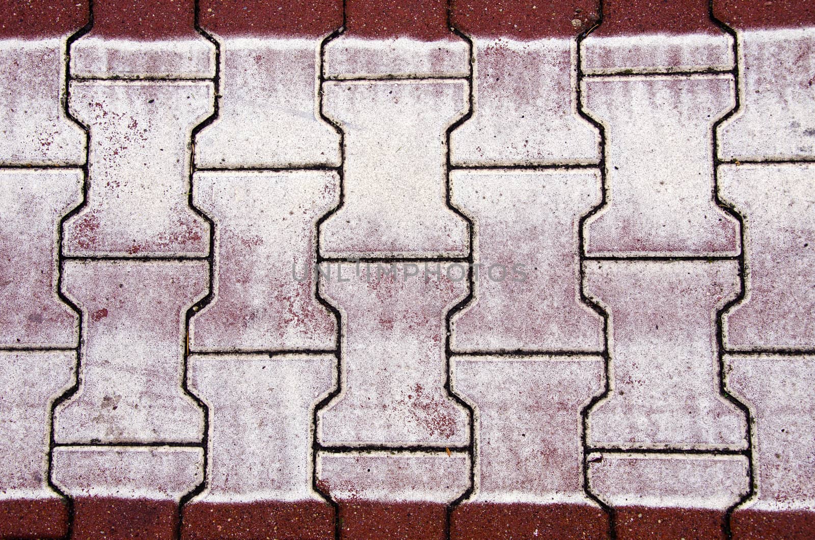 background of city street bricks. pedestrian crossing markings on road.