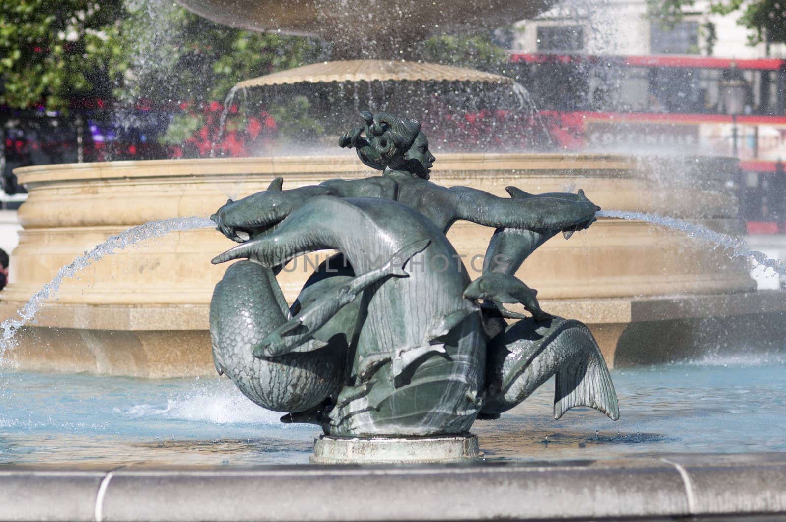 Detail of statue by water fountain in Trafalgar Square, central London, UK